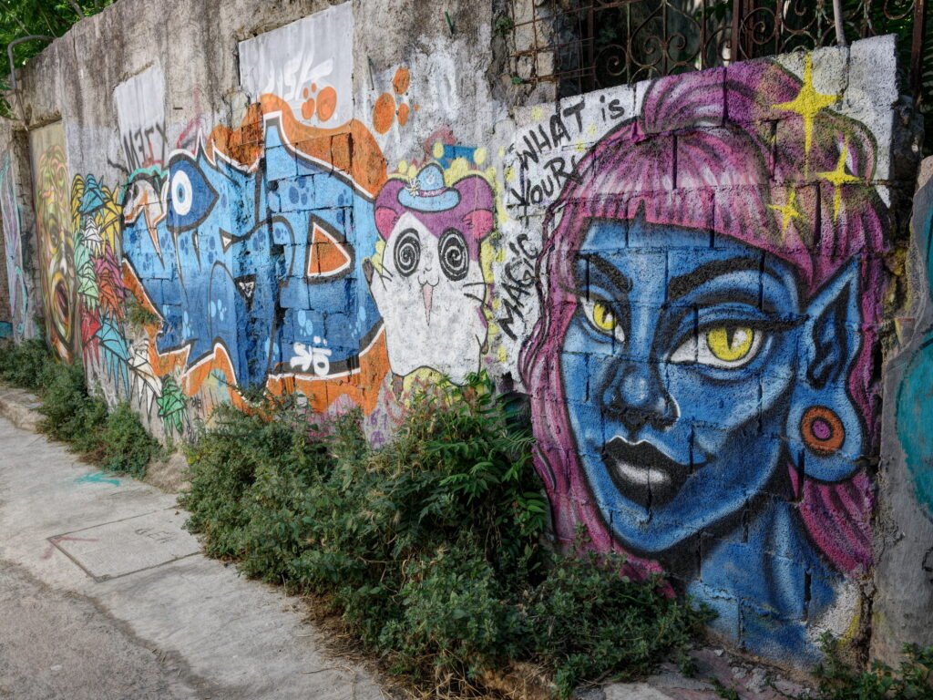 Brightly colored and rather skillful graffiti painted on a stone wall in Anafiotika.